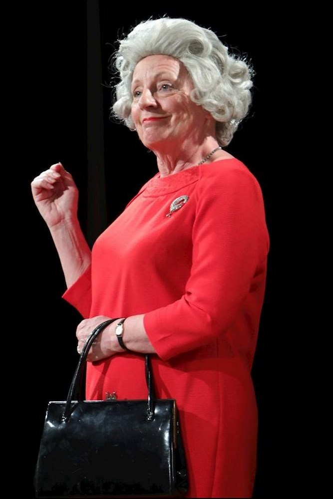 Jane Fosbrook as Q in Handbagged (2019).
